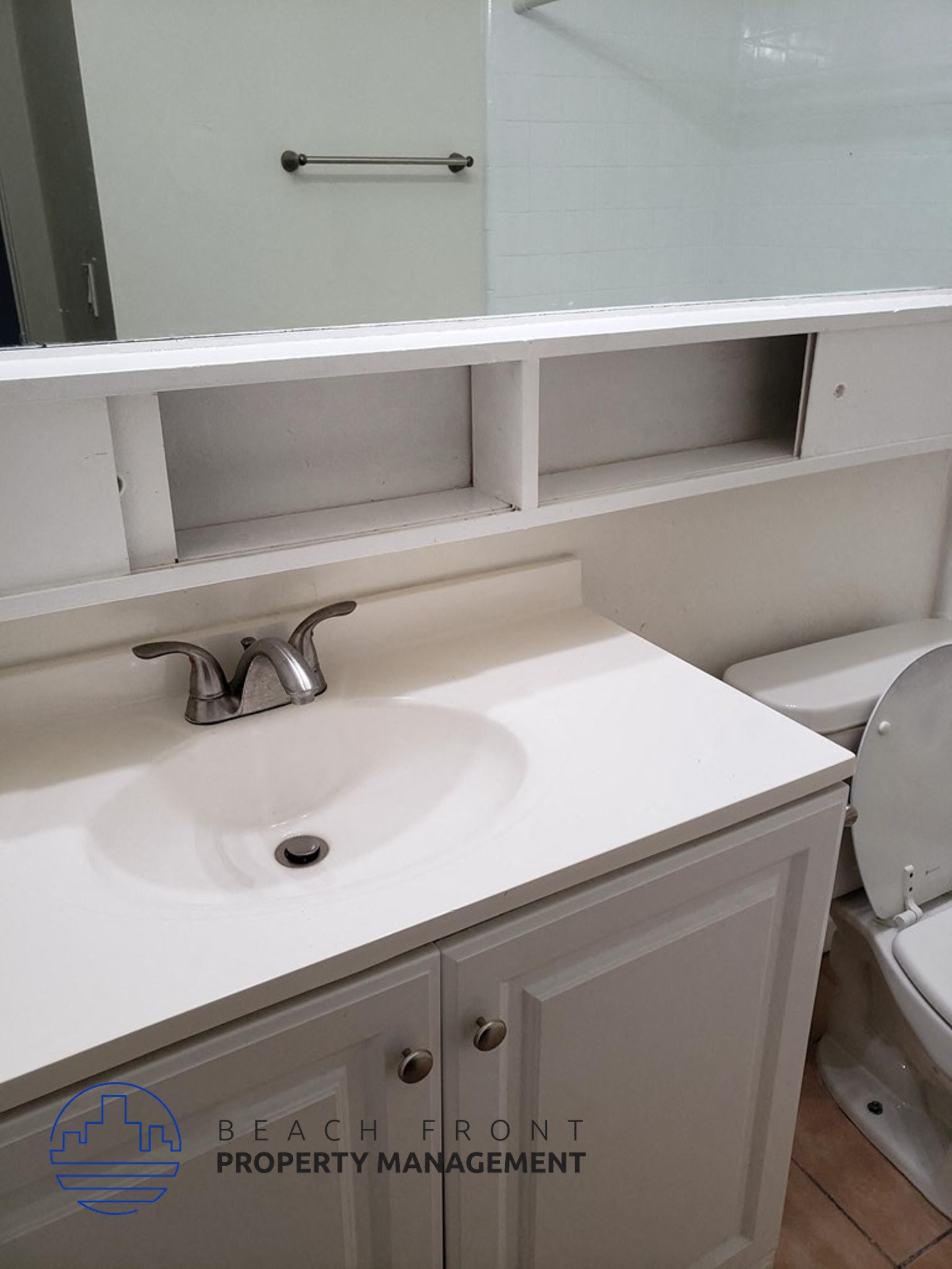 a bathroom with a sink and a mirror and a toilet